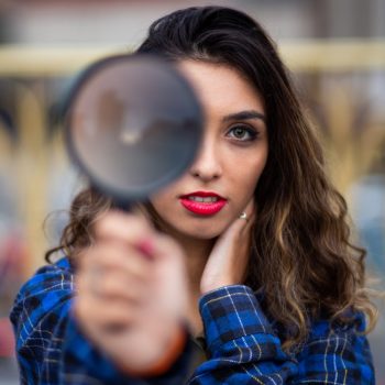 Woman holding a Magnifying Glass