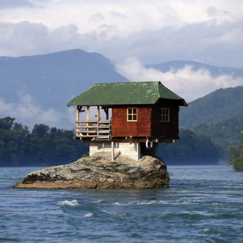 A house built on a rock on the river Drina is seen near the western Serbian town of Bajina Basta, about 160km (99 miles) from the capital Belgrade May 22, 2013. The house was built in 1968 by a group of young men who decided that the rock on the river was an ideal place for a tiny shelter, according to the house's co-owner, who was among those involved in its construction.  REUTERS/Marko Djurica (SERBIA - Tags: ENVIRONMENT SOCIETY TRAVEL TPX IMAGES OF THE DAY) - RTXZWGT
